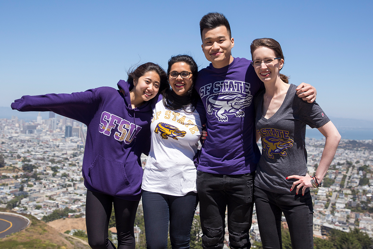 SF State students smiling wearing their SF State merchandise